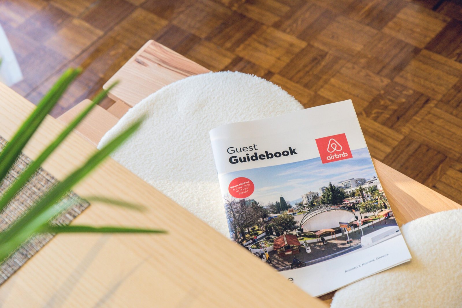 Nos Services Airbnb Guest Guidebook on a modern table in Kavala, Greece home.